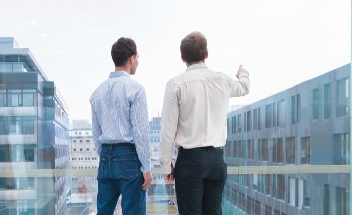 choosing a china joint venture legal representative two men looking out towards city