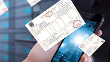 China’s ‘fapiao’ invoice next to man holding a phone 